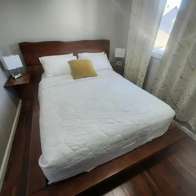 a bedroom with a bed with white sheets and pillows at Modern Family Home with guest heat garage, Pet-Friendly!- NO BASEMENT in Edmonton