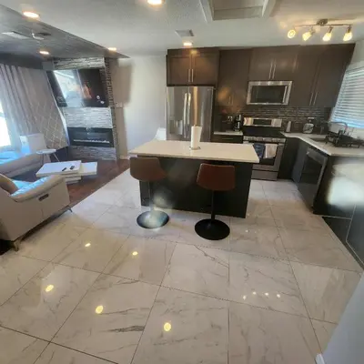 a large kitchen with a island in the middle at Modern Family Home with guest heat garage, Pet-Friendly!- NO BASEMENT in Edmonton