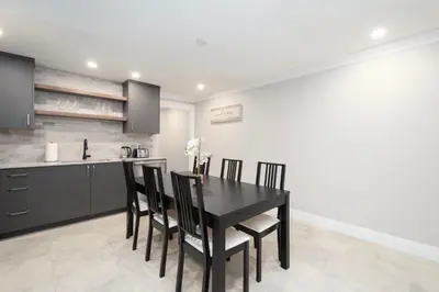 a dining room with a black table and chairs at Elegant and Roomy Forest Getaway in North Vancouver