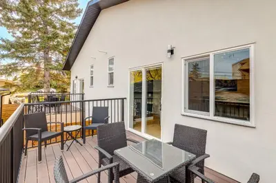 a patio with a table and chairs on a balcony at Long Stays, Pets Welcome, Free Parking & King Bed in Calgary