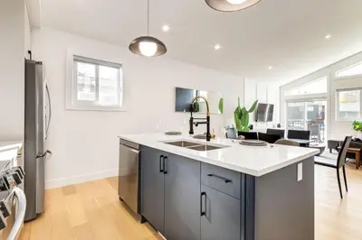 a kitchen with a sink and a refrigerator at Free Parking, Perfect Family Home with King Bed in Calgary