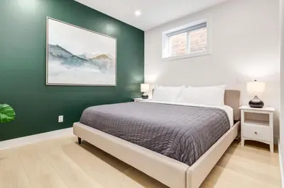 a bedroom with a bed and a green wall at Free Parking, Perfect Family Home with King Bed in Calgary