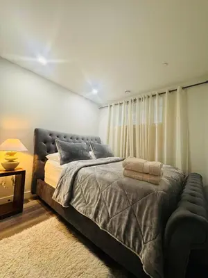 a bedroom with a large bed and a window at Comfy Neutral Living Free Parking in Calgary