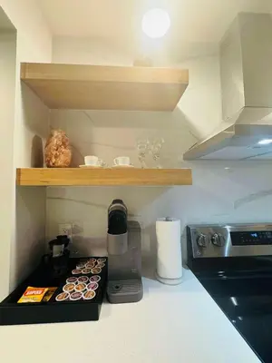a kitchen with a counter with a tray of cupcakes at Comfy Neutral Living Free Parking in Calgary