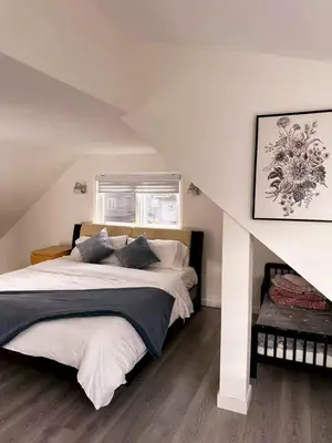 a bedroom with a large bed in a attic at Elmshade Villa in Vancouver South in Vancouver