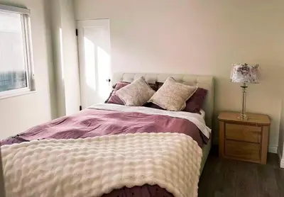 a bedroom with a large bed with a window at Elmshade Villa in Vancouver South in Vancouver