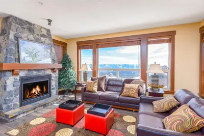 a living room with a couch and a fireplace at Stonegate Resort Unit C105 in Kelowna