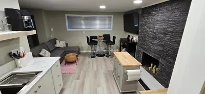 a living room with a couch and a fireplace at 1 block to Kelowna General Hospital 2 blocks to Beach 1km to OUC 1km to Downtown Kelowna 20min to YLW in Kelowna