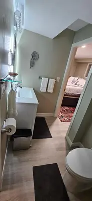 a bathroom with a sink and a toilet and a bed at 1 block to Kelowna General Hospital 2 blocks to Beach 1km to OUC 1km to Downtown Kelowna 20min to YLW in Kelowna