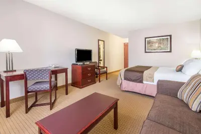 a hotel room with a bed and a desk at Gold Circle Inn in Lloydminster