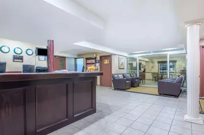 a lobby with a bar and a living room at Gold Circle Inn in Lloydminster
