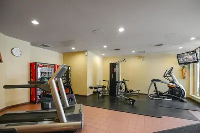 a gym with treadmills and exercise bikes in a room at KING Bed STUDIO in the Village in Whistler