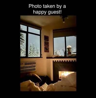 a living room with a fireplace and a christmas tree at Ideal Central Village Location! in Whistler