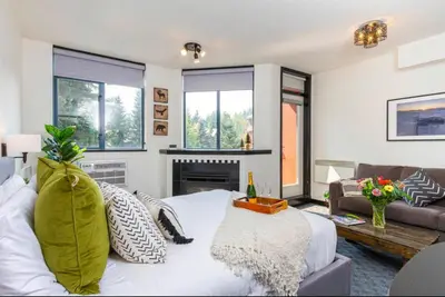 a living room with a bed and a couch at Ideal Central Village Location! in Whistler