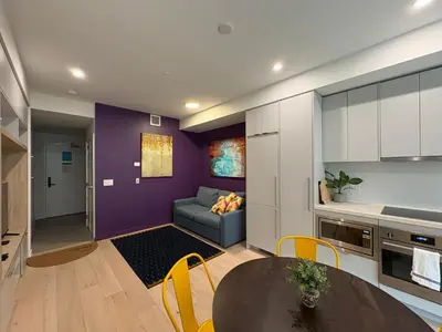 a kitchen and living room with a table and a couch at RED Mountain Gem in Trail
