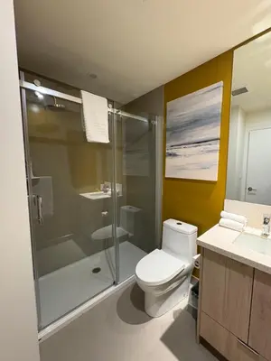 a bathroom with a toilet and a glass shower at Premium RED Mountain Lodging in Trail