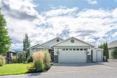 a house with a white garage at Licensed 2-Bedroom Suite Eco-Friendly Solar Home in Kelowna