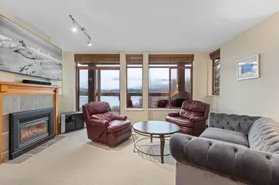 a living room with a couch and chairs and a fireplace at Nicklaus North - Clubhouse by Whistler Premier in Whistler