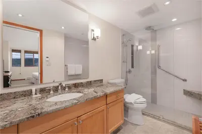 a bathroom with a sink and a shower and a toilet at Nicklaus North - Clubhouse by Whistler Premier in Whistler