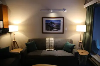 a living room with a couch and two lamps at Tantalus Lodge by Elevate Vacations in Whistler