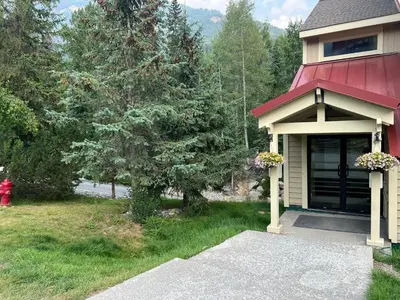 a house with a red roof and a driveway at Toby Creek Lodge by StayIn in Panorama