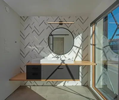a bathroom with a mirror and a sink at Nest Luxury Modern Lake House in Penticton