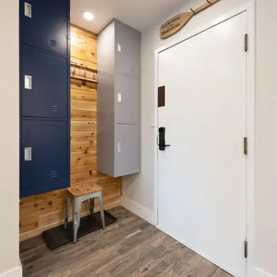 a closet with blue cabinets and a wooden wall at Whistler Village Center - Newly Renovated Condo in Whistler
