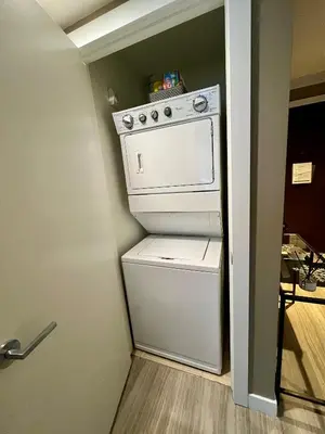 a small kitchen with a white washer and dryer at Century Park Condo Oasis in Edmonton