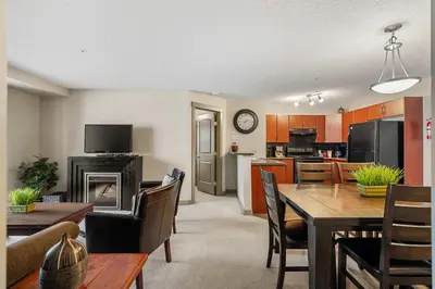 a living room with a dining table and a kitchen at Aspen Retreat in Invermere