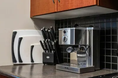 a kitchen counter with a coffee maker and knives at Aspen Retreat in Invermere