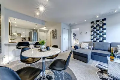 a living room with a couch and a table and chairs at Ski-In-Out, Pool, Hot Tub, Sauna in Whistler