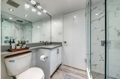 a bathroom with a toilet and a glass shower at Ski-In-Out, Pool, Hot Tub, Sauna in Whistler