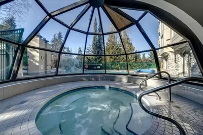 a hot tub in a room with a glass dome at Ski-In-Out, Pool, Hot Tub, Sauna in Whistler