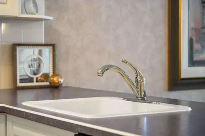 a white sink in a kitchen with a mirror at Vista in Fairmont Hot Springs
