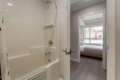 a bathroom with a door leading to a bedroom at Free Parking, Close to Downtown, Pet Friendly in Calgary