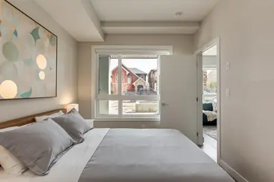 a bedroom with a large bed and a window at Free Parking, Close to Downtown, Pet Friendly in Calgary
