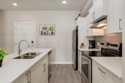 a kitchen with white counters and a sink at Free Parking, Close to Downtown, Pet Friendly in Calgary