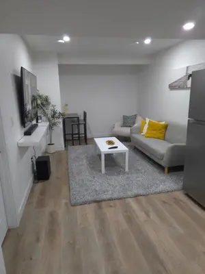 a living room with a couch and a table at Staycation3179 in Edmonton