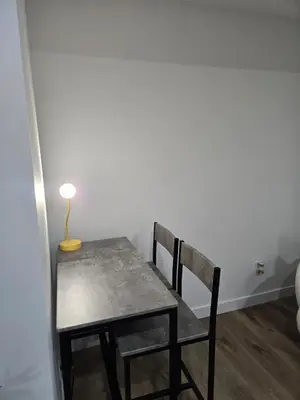 a table with two chairs and a lamp on it at Staycation3179 in Edmonton