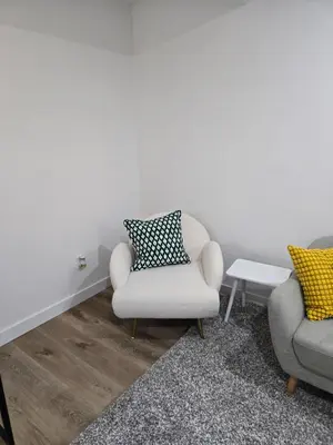 a living room with two chairs and a table at Staycation3179 in Edmonton