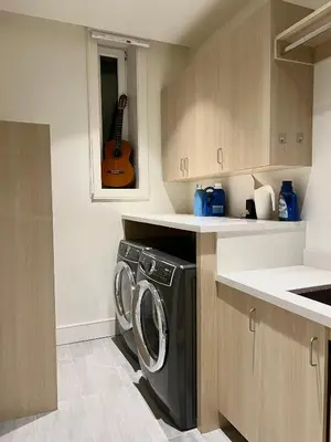 a kitchen with a washing machine and a guitar at Cozy&Private Suite in Vancouver in Vancouver