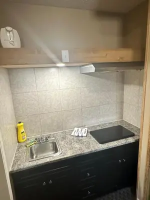 a kitchen with a sink and a counter top at Voyageur Motel in Rocky Mountain House