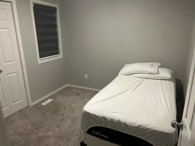 a small bedroom with a bed in a room at Bedroom SW Edmonton HWY 2 near YEG in Edmonton