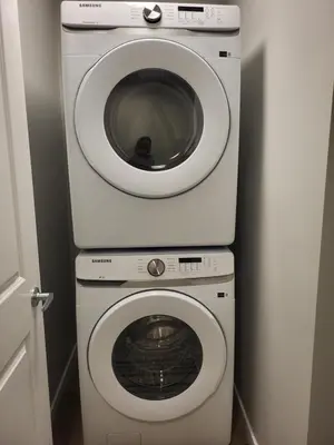 a washing machine and a dryer in a bathroom at Home away from Home in Calgary