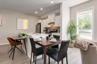 a kitchen and dining room with a table and chairs at Inner City Apartment, Pet Friendly, Free Underground Parking in Calgary