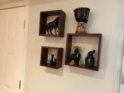 a wall with three pictures and a trophy on it at Place near the Coquitlam River Park in Coquitlam