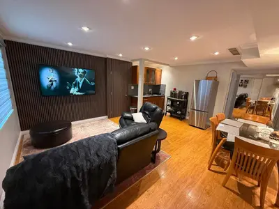 a living room with a couch and a flat screen tv at Place near the Coquitlam River Park in Coquitlam
