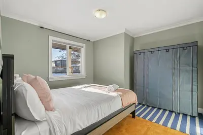 a bedroom with a large bed and a window at Home Alone Retreat in Calgary