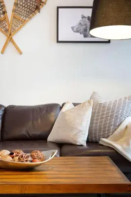 a living room with a couch with a bowl of food on a table at Northstar Whistler Village Resort in Whistler