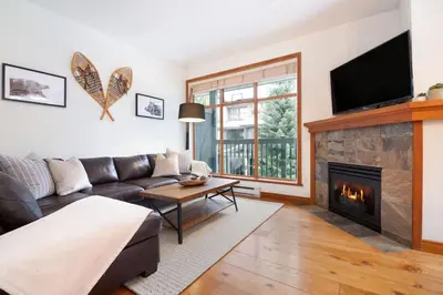 a living room with a couch and a fireplace at Northstar Whistler Village Resort in Whistler